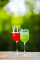 Summer cocktail. Fruit cocktail on green background. Citrus fruits, berries, strawberries, blueberries, mint, ice.