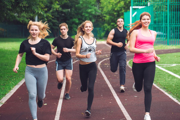 Professional runners running on a race track.