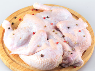 raw chicken carcass on the cutting board isolated on white background