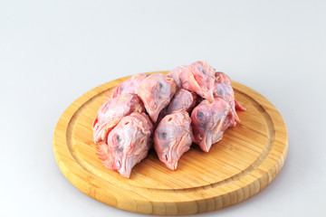 raw chicken heads on a white background