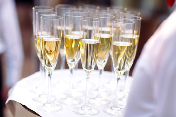 Glasses with champagne on a tray. Meeting the guests.