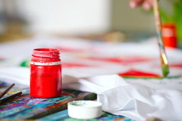 Drawing on clothes. Girl draws on a white T-shirt.