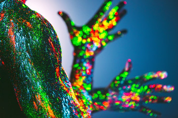 The man is decorated in a ultraviolet powder.