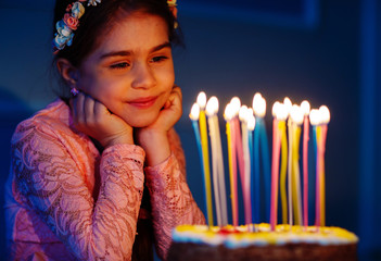 Portrait of little pretty girl with birthday cake