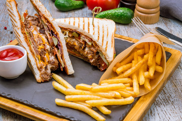 club sandwich with meat and French fries