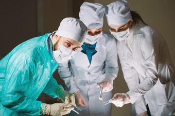 The surgeon makes an operation.