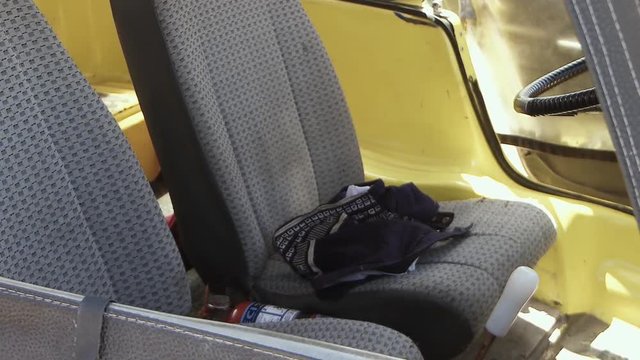 Undressing On The Beach. Clothes Falling Inside Of A Yellow Car.