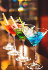 Multicolored cocktails at the bar.