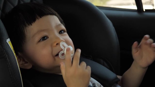 cute child happy in car seat