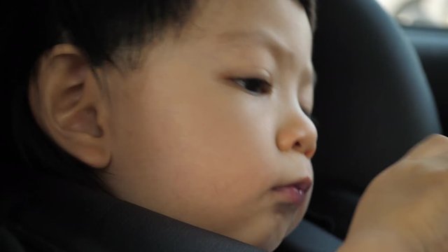 cute child happy in car seat