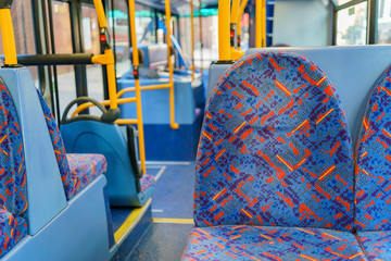 Interior view of a bus with empty seat