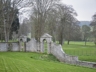 Country side view with a stone wall and gate