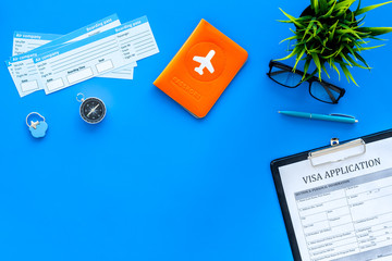 Documents for travel abroad. Visa application form, pen, passport cover with airplane silhouette,...