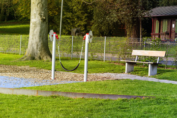 Swing playground on yard in the park with gradd