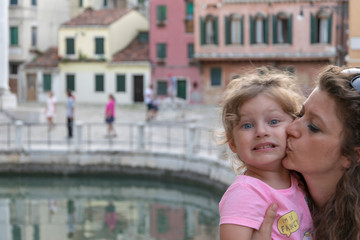 Fototapeta na wymiar young mother and little daughter posing in venice