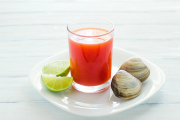 caldo de almeja, consome de almejas, clam cocktail with lemon mexican sea food in mexico