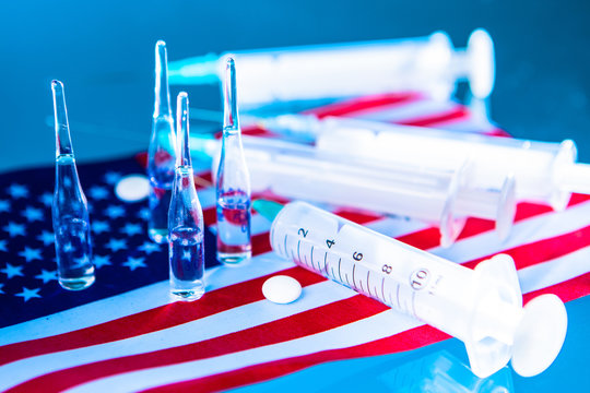 Packs of dollars against the background of syringes. Paid medicine in America. Medical insurance. Expensive treatment in the USA. Payment for medical services. Healthcare in the USA. 