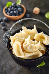 Dumplings with Blueberries. Berriesjiaozi, Dimsum, Momo or Ha Gao on Dark Background