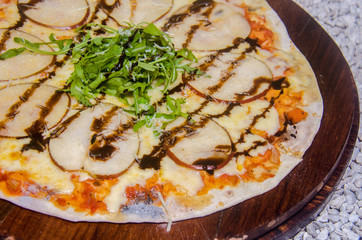 Handmade pear pizza prepared on a clay furnace