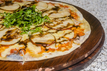 handmade pear pizza prepared on a clay furnace