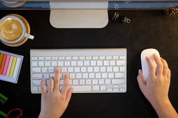 Top view designer  using desktop computer at office desk.