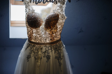 Fototapeta na wymiar White dress with lace at the window