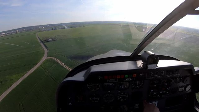 Pilot and cockpit's view of a landing in Chavenay, on board a light single engine propeller aircraft.