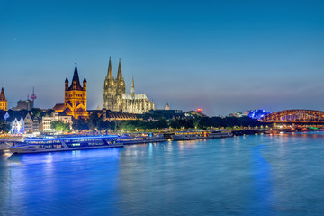 The famous skyline of Cologne with the river Rhine at dusk