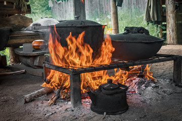 Cook food on burning campfire. Cooking on an open fire. Outdoor cooking. Outdoor food.
