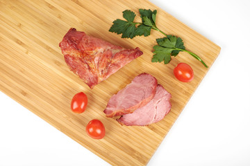 Cooked sliced pork barbecue steak on wooden cutting board on the white background