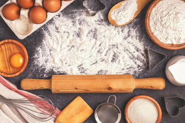 Ingredients for baking  - flour, wooden spoon, rolling pin, eggs