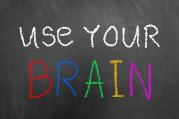 Use your brain chalk text on blackboard or chalkboard.