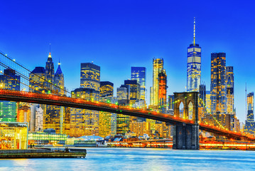 New York night view of the Lower Manhattan and the Brooklyn Bridge across the East River.