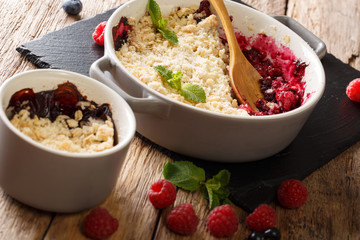 crumble mix of currants, raspberries and blueberries decorated with mint close up. horizontal