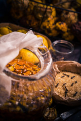 Ingredients tinctures Fruits twigs quince sugar cloves vanilla wooden table