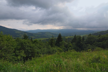 Fototapeta na wymiar Nature in the mountains. Stunning mountain landscape of Ukrainan Carpathian. View from the top of Verecke Pass. Cloudy summer day. Zakarpatska oblast, Ukraine