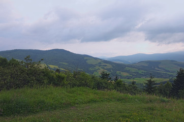 Fototapeta na wymiar Stunning mountain landscape of Ukrainan Carpathian. View from the top of Verecke Pass. Cloudy summer day. Zakarpatska oblast, Ukraine