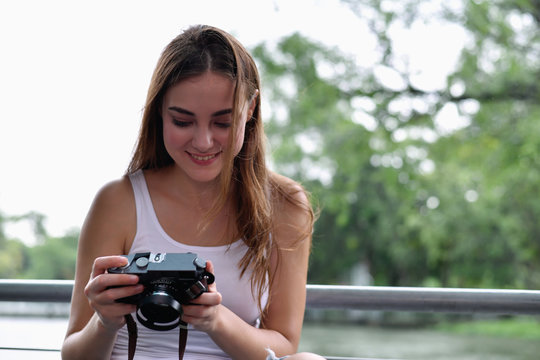 Travel concept. beautiful girls are traveling in the woods.  Beautiful women are taking photos in the forest.