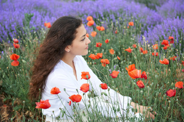 young girl portrait is in the lavender field, beautiful summer landscape with flowers