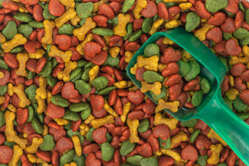 dry dog food , meat snack biscuits background with spoon .