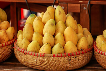 Yellow mango in a basket on the market