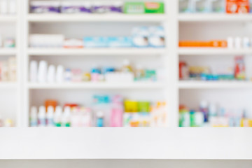 Pharmacy drugstore counter table with blur abstract backbround with medicine and healthcare product on shelves