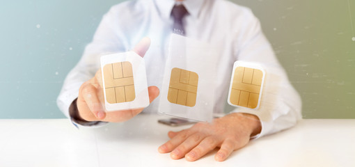 Businessman holding Different size of a smartphone sim card 3d rendering