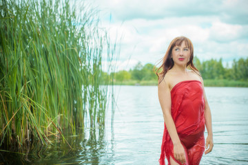 Mermaid. Beautiful lady at lace. Midsummer. Portrait of slavic or baltic woman in river near reeds. Summertime, ethnic 