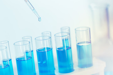 Science Glass test tube blue color in research lab for sci background wallpaper.