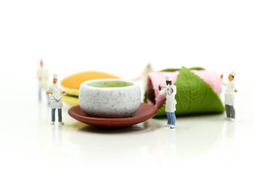 Obraz na płótnie Canvas Miniature people : chef and friend with Dessert Japanese traditional confectionery,Sakura Mochi,matcha green tea,Dorayaki