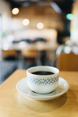 Coffee on the wooden table with plenty of natural light