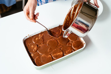 Close up of hand preparing homemade chocolate cake
