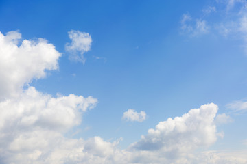 White clouds on blue sky background.
