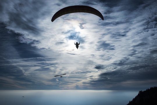Paraglider against cloudy sky, Roquebrune, Cote d`Azur, Mediterranean, France, Europe